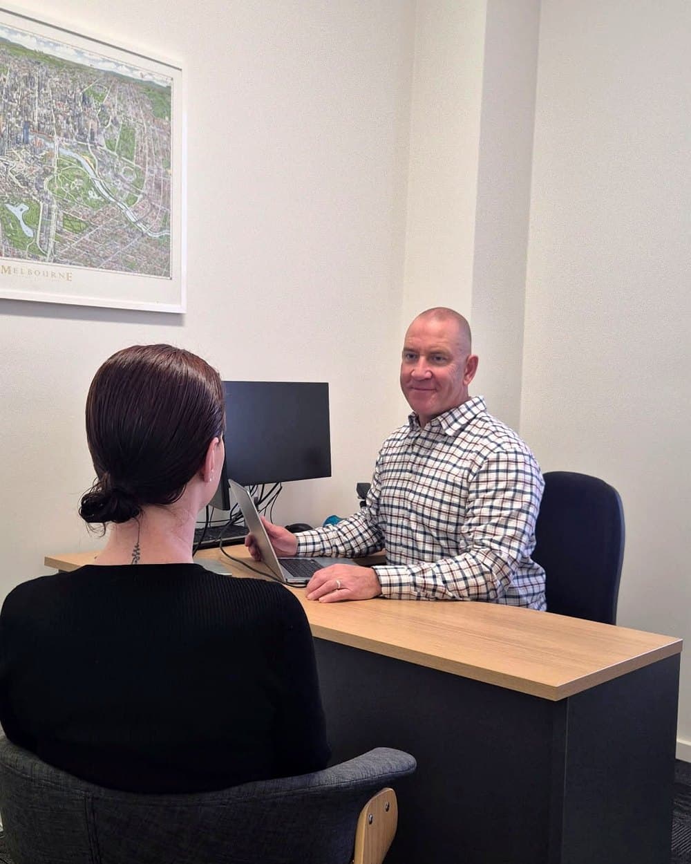 Adrian Hallam in consultation with a client at his Warrnambool clinic